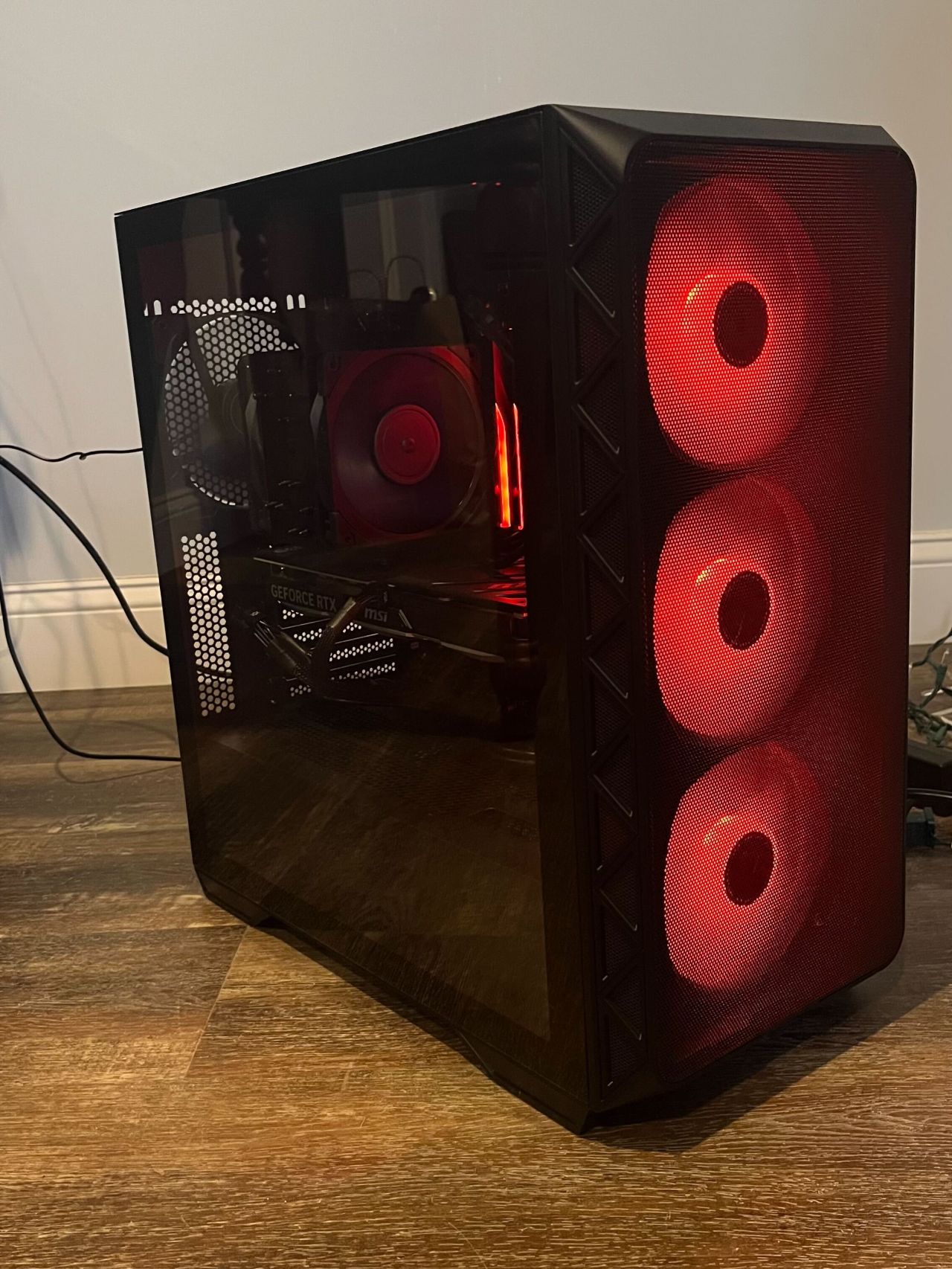A newly built PC tower with red glowing fans.